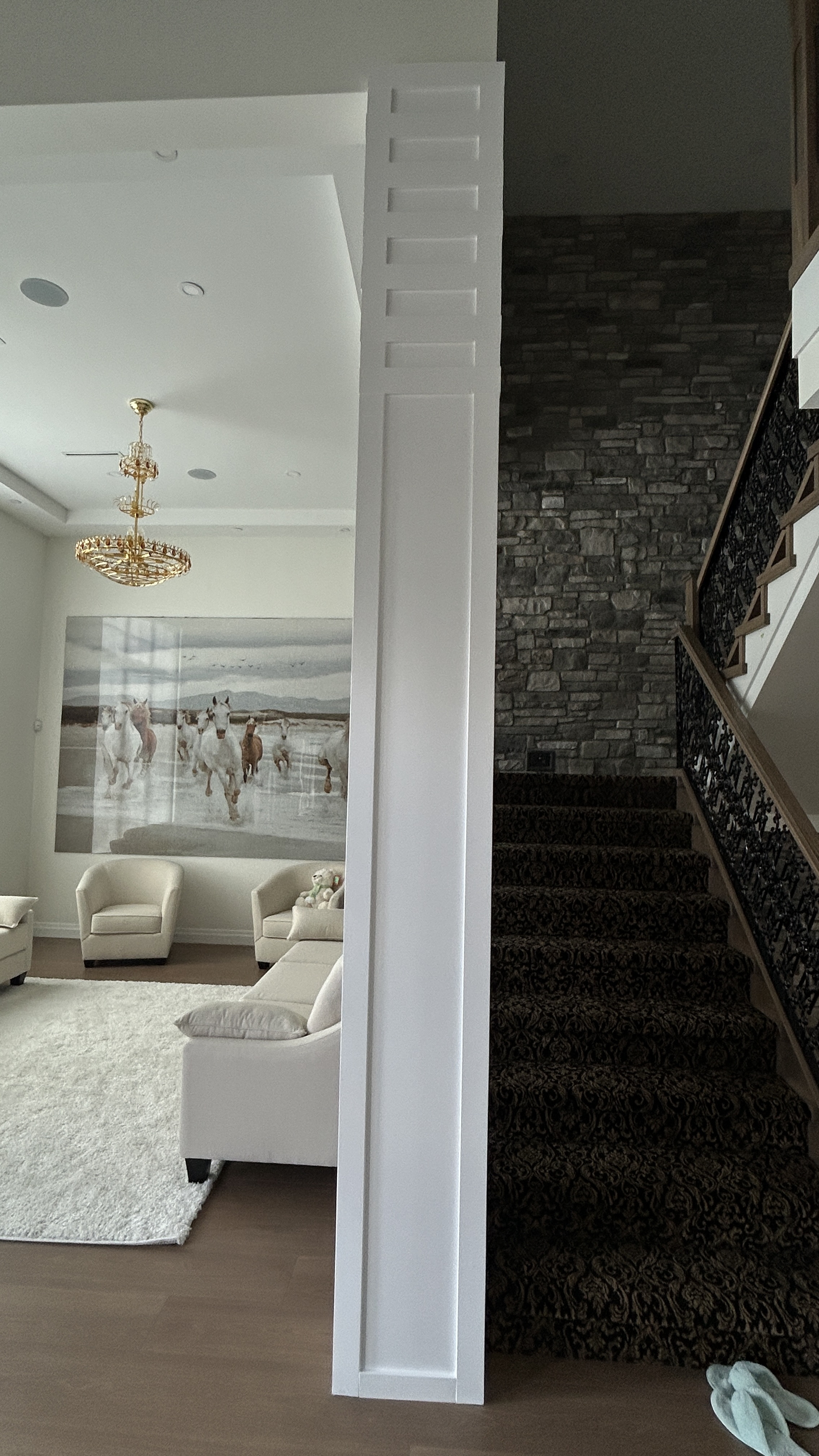 Interior trim work with custom column detail and staircase