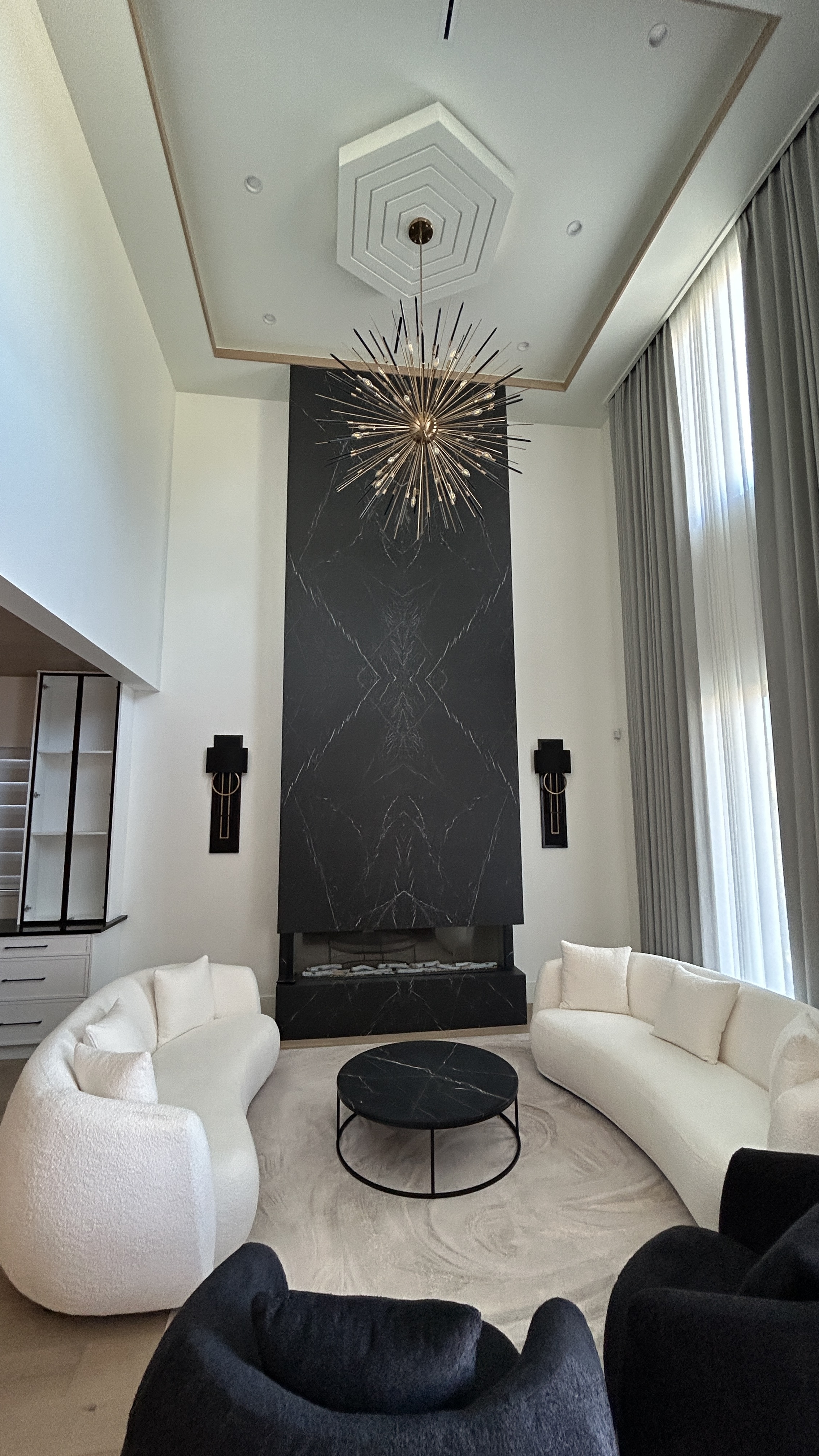 Luxury living room with marble fireplace feature wall and custom ceiling detail