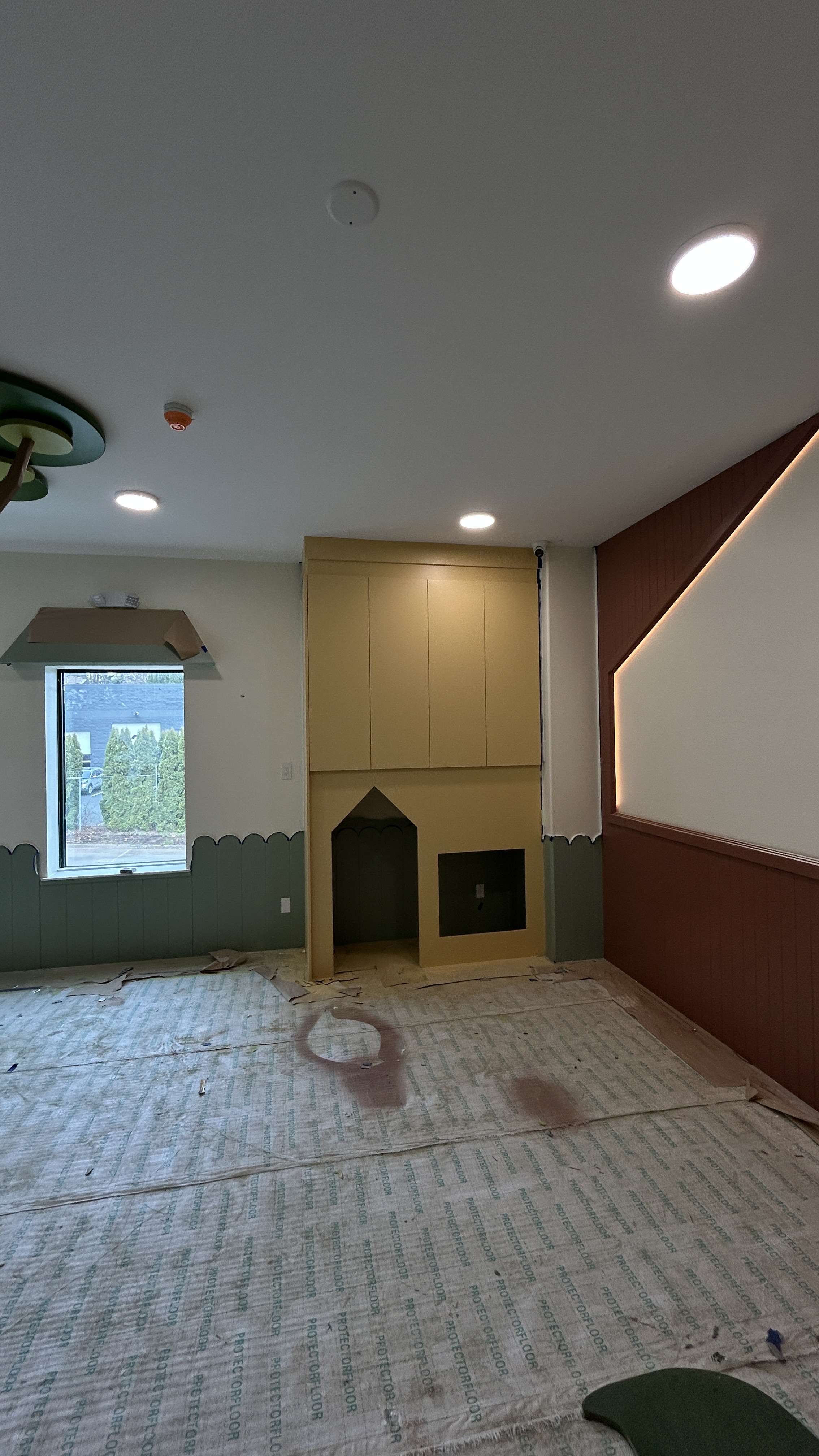 Custom built-in playhouse with accent wall paneling