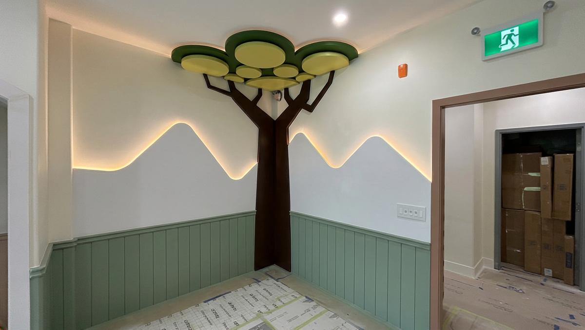 Custom tree feature wall with LED backlighting and mountain mural